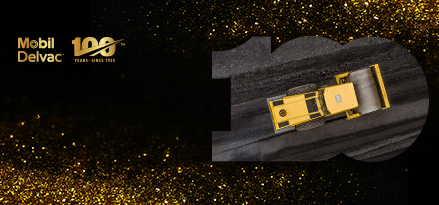 Excavator rolling over some tarmac with gold sparkles