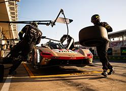 A racing Porsche WEC car in the pit